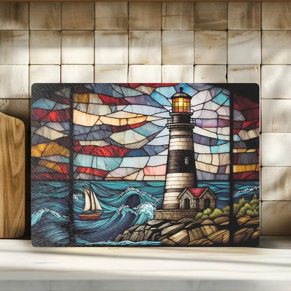 Stained glass-style artwork of a lighthouse and sailboat on a wooden surface.