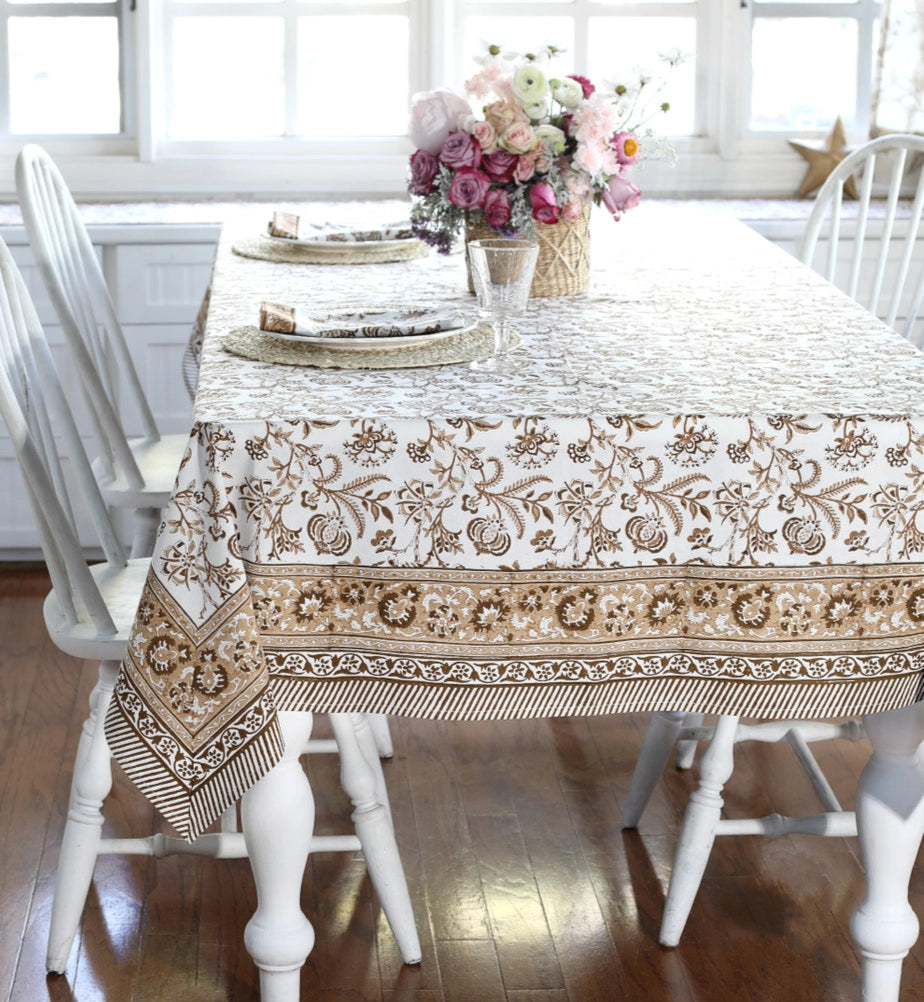 Dining table with a patterned tablecloth in a bright room