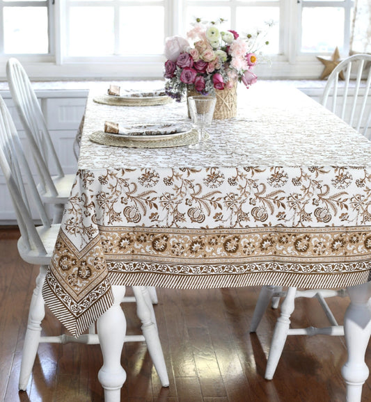 Dining table with a patterned tablecloth in a bright room