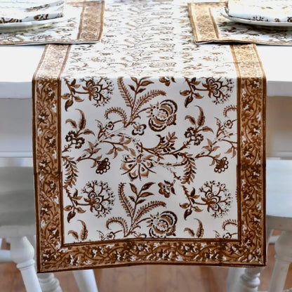 Decorative table runner with floral pattern on a white table