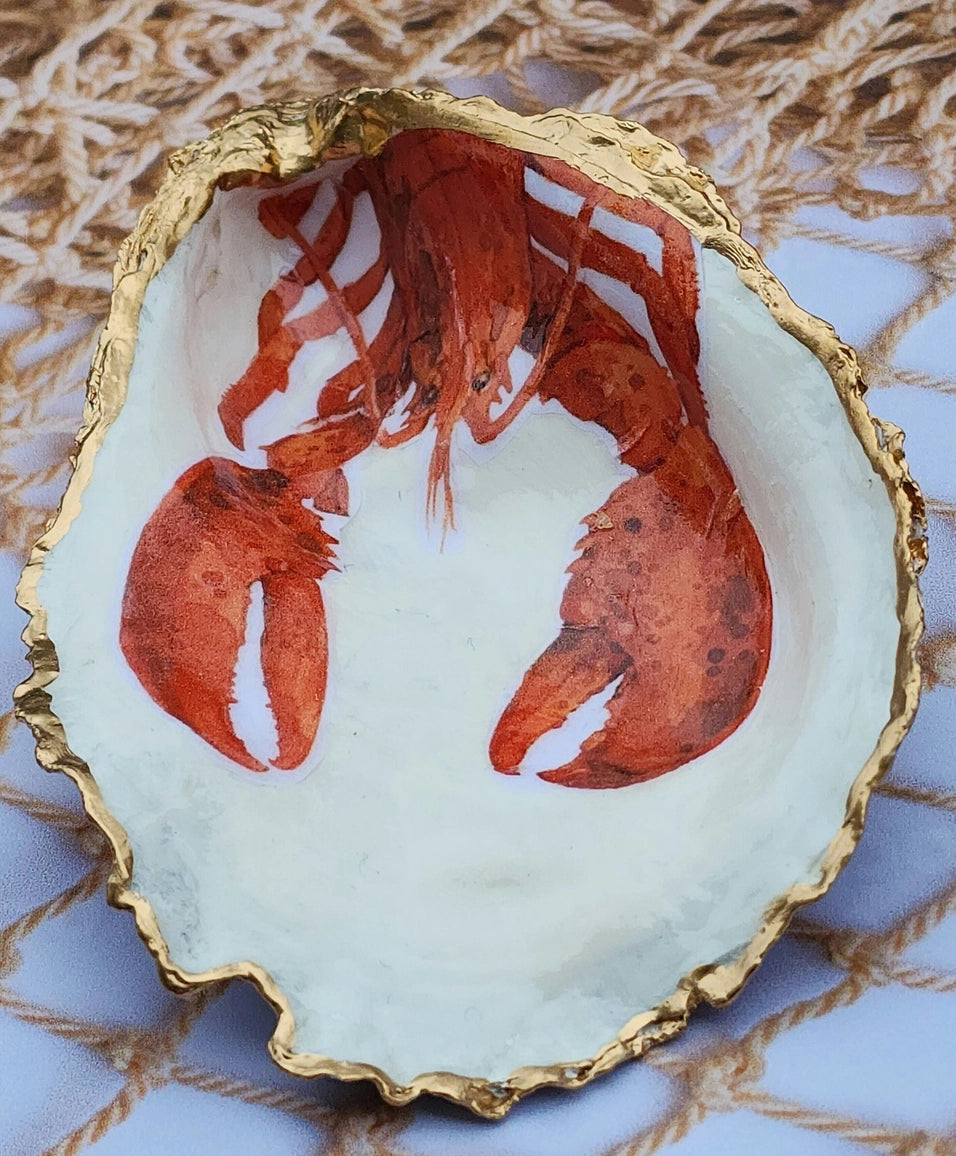 Decorative plate with a red lobster design on a textured surface