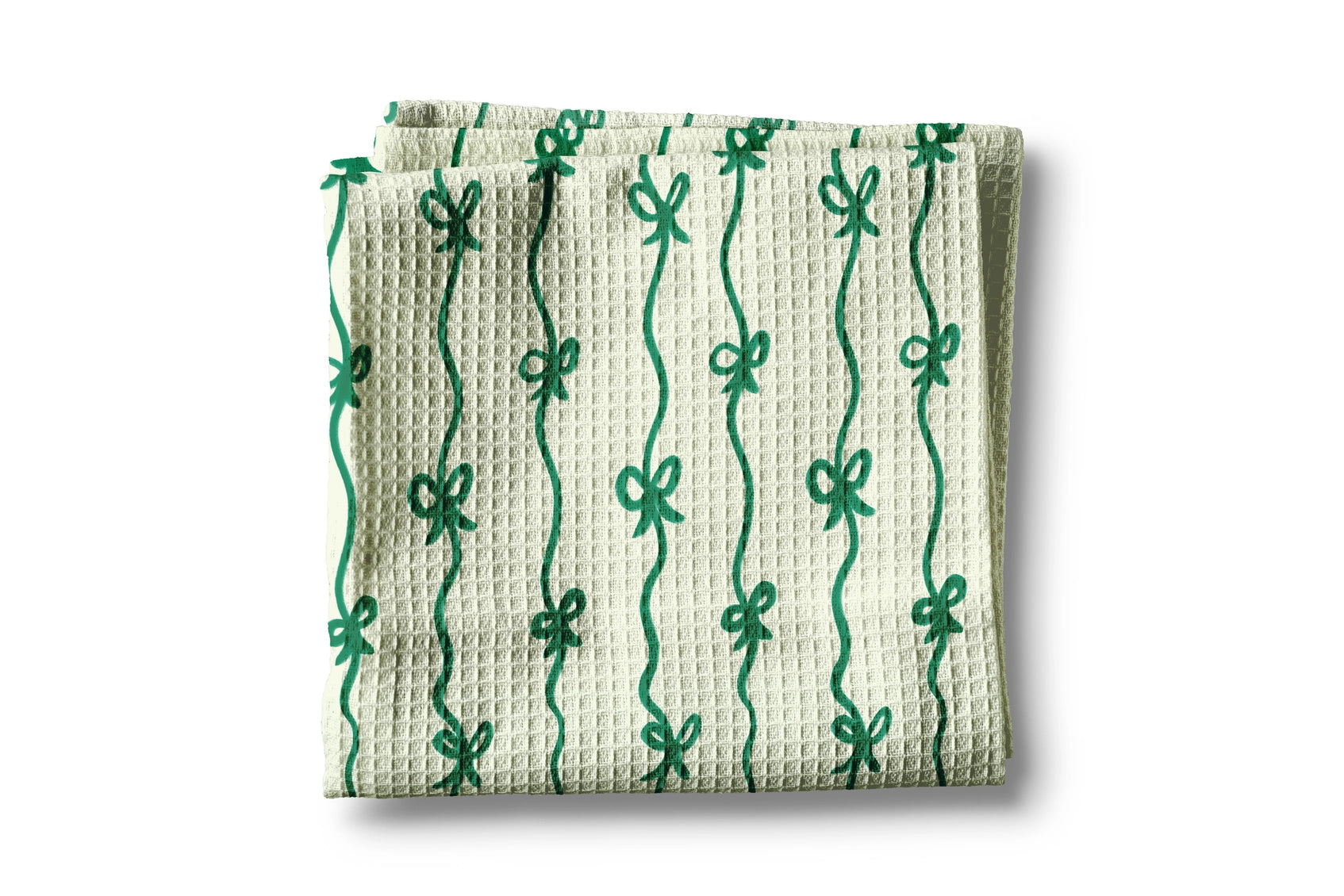 Waffle-textured towel with green bow pattern on a white background