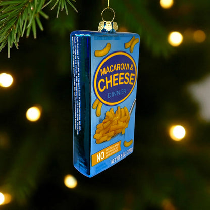 Macaroni and cheese box ornament hanging on a Christmas tree.