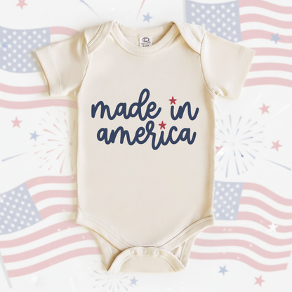 Baby onesie with 'made in america' text on a white background