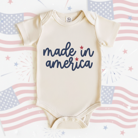 Baby onesie with 'made in america' text on a white background