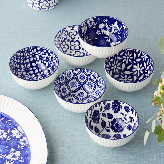Set of blue and white patterned ceramic bowls on a light blue background