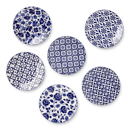 Set of six blue and white patterned plates on a white background