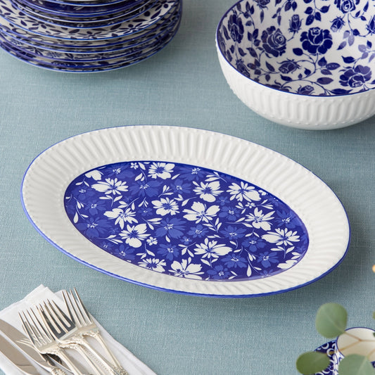 Blue and white floral-patterned plates and bowls on a light blue tablecloth.
