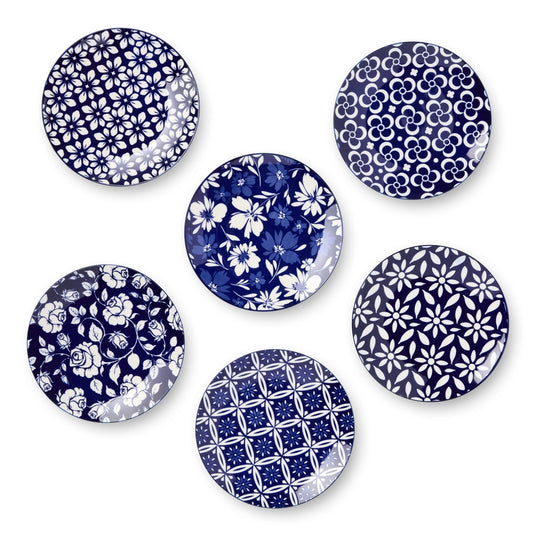 Set of six blue and white patterned plates on a white background