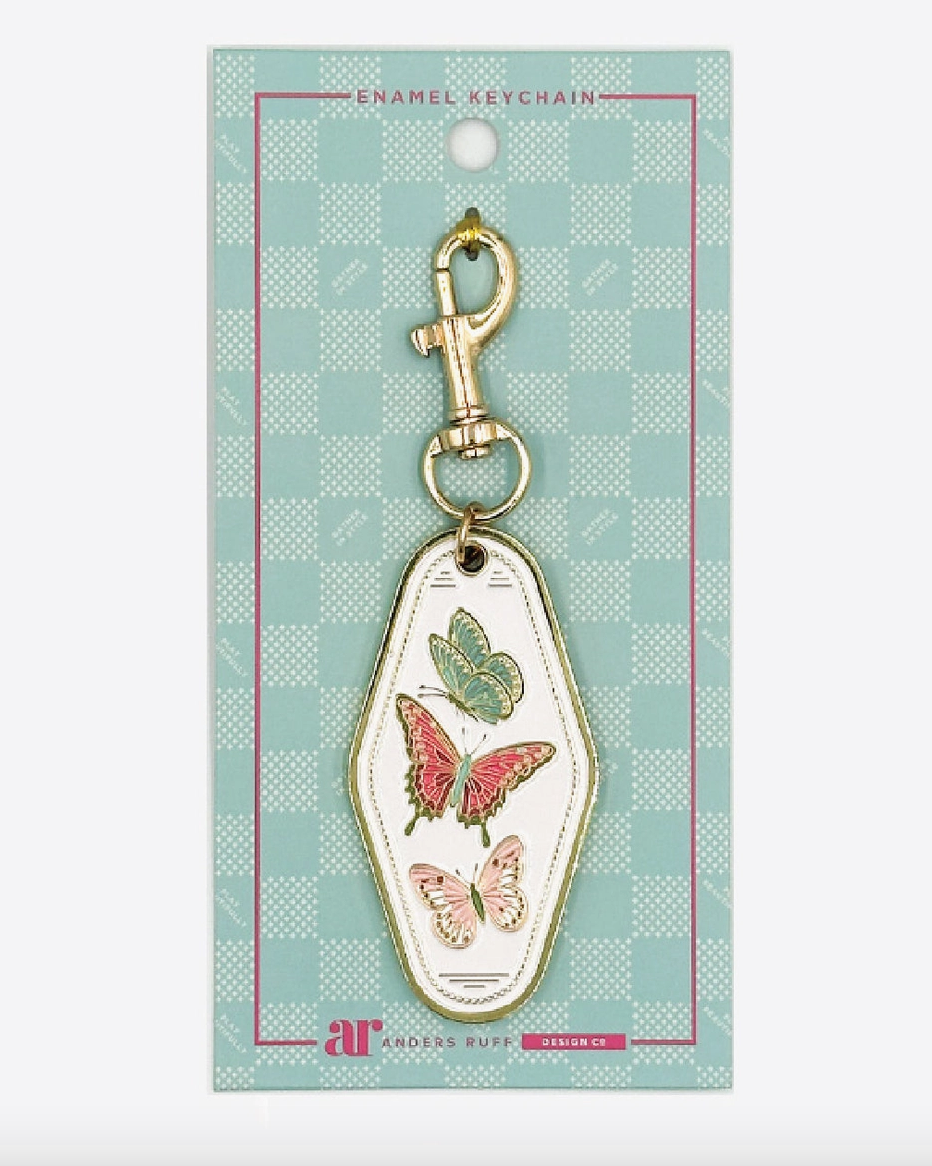 Mahj in Bloom butterfly Mahjong enamel keychain charm by Anders Ruff with teal, pink and blush butterflies, ivory enamel and gold-tone hardware.
