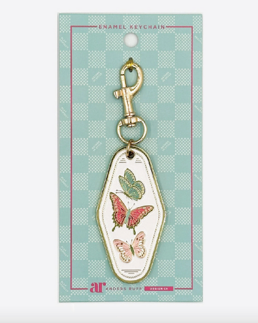 Mahj in Bloom butterfly Mahjong enamel keychain charm by Anders Ruff with teal, pink and blush butterflies, ivory enamel and gold-tone hardware.
