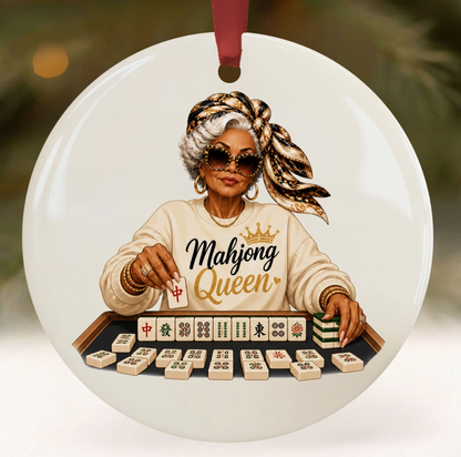 Mahjong Queen ceramic Christmas ornament with woman wearing sunglasses and patterned headscarf seated behind Mahjong tiles.