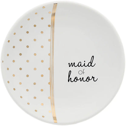 A round white plate with gold polka dots on the left half, a vertical gold stripe down the center, and the words 'maid of honor' in black script on the right half.