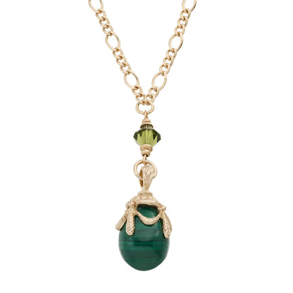 Necklace with a green pendant and gold chain on a white background