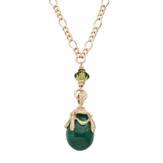 Necklace with a green pendant and gold chain on a white background