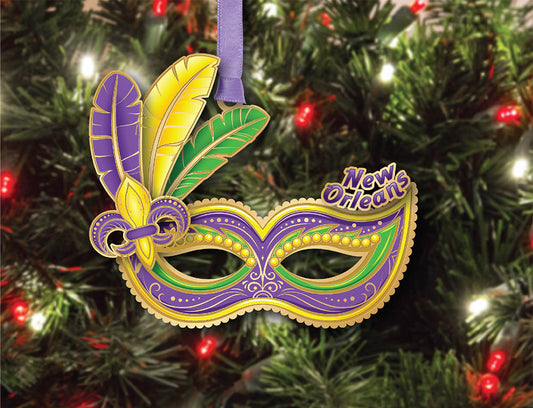 Mardi Gras mask ornament with 'New Orleans' text on a Christmas tree.