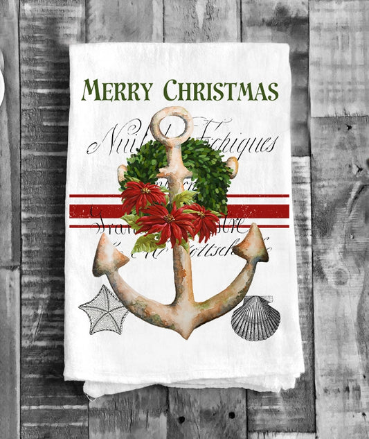 Christmas-themed towel with anchor, wreath, and poinsettia on a wooden background