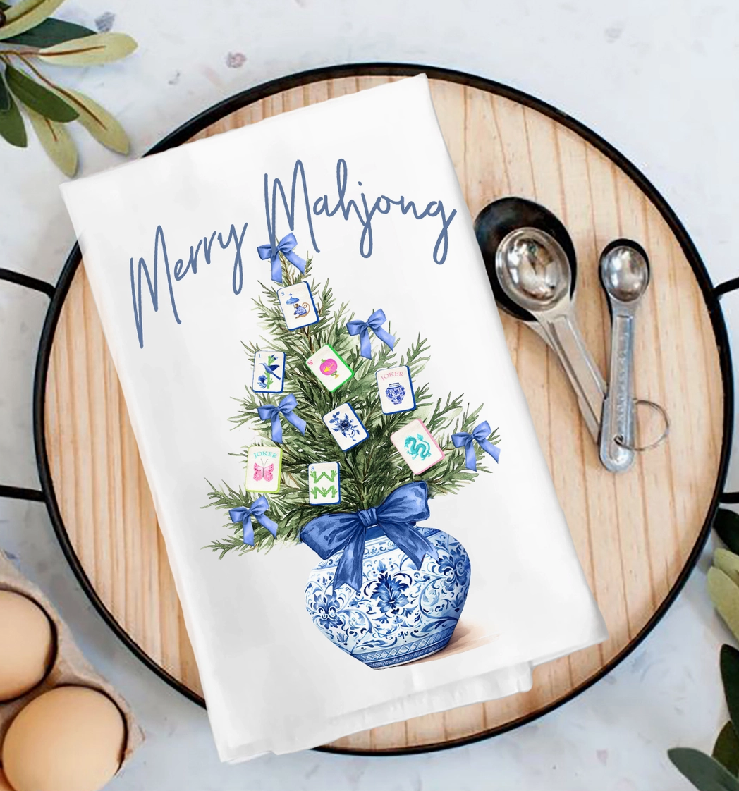 Merry Mahjong Christmas tea towel with Mahjong tile Christmas tree, blue bows and blue-and-white chinoiserie vase