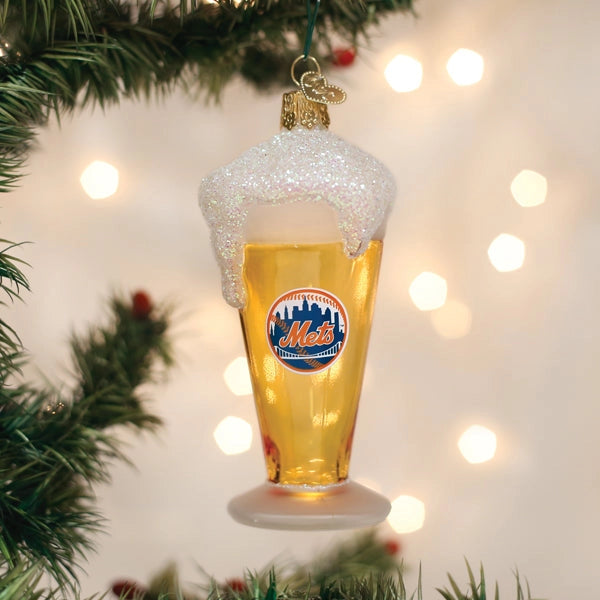 Christmas ornament shaped like a beer glass with foam, featuring a logo, on a decorated Christmas tree.