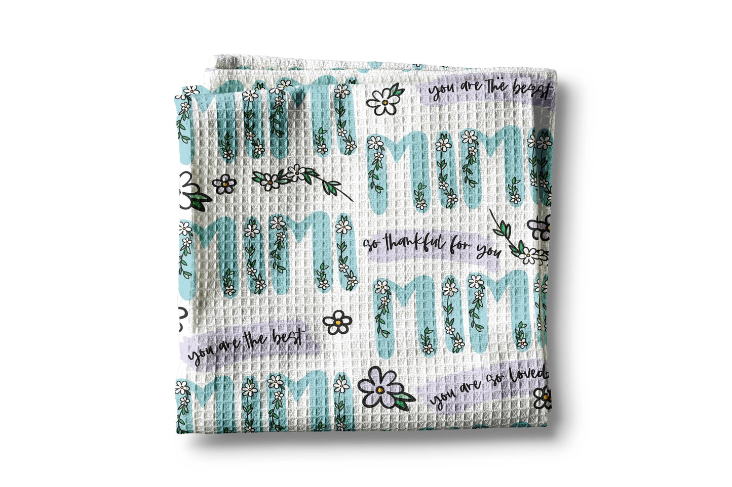 Waffle-textured blanket with 'mom' text and floral designs on a white background