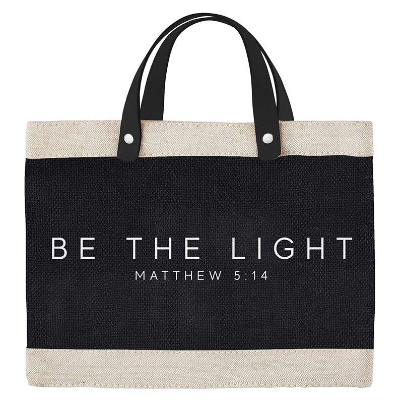 Tote bag with 'Be the Light' text on a white background