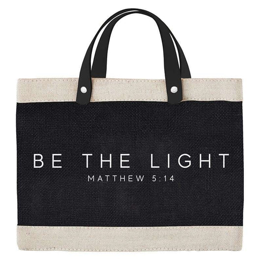 Tote bag with 'Be the Light' text on a white background
