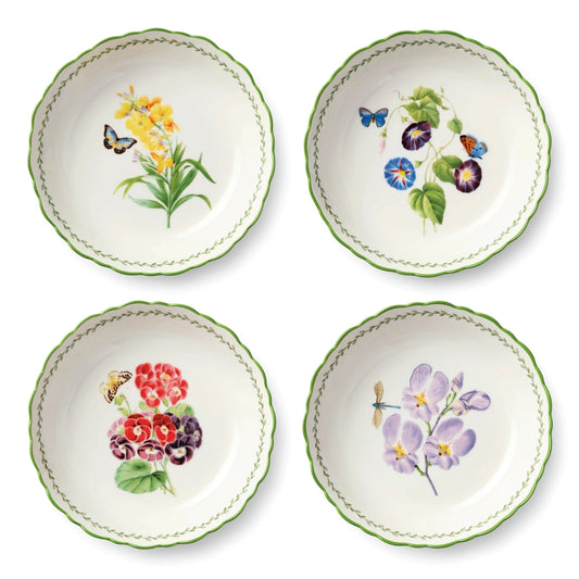 Four ceramic plates with floral and butterfly designs on a white background