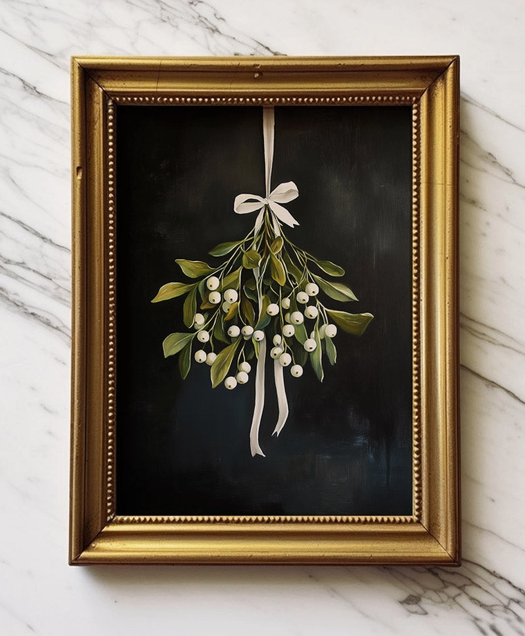 Mistletoe Christmas art print with green leaves, white berries and white ribbon on a black background displayed in a gold frame