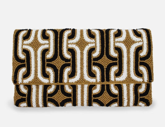 Patterned clutch bag with black, gold, and white design on a white background
