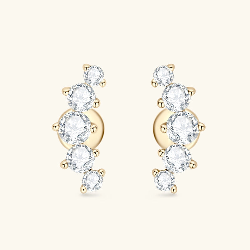 Gold earrings with clear gemstones on a white background