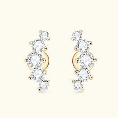 Gold earrings with clear gemstones on a white background