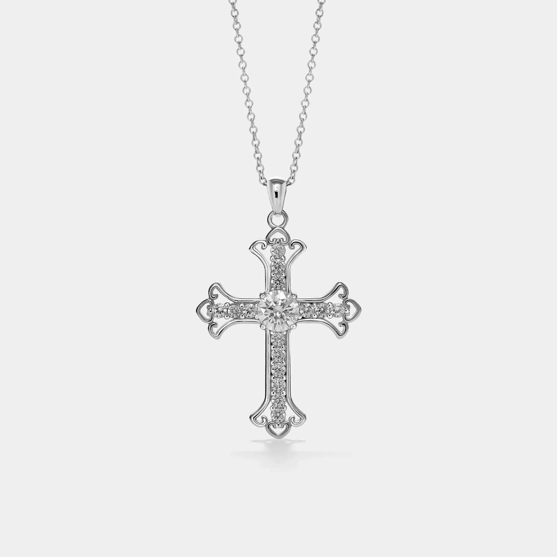 Silver cross pendant necklace on a light gray background