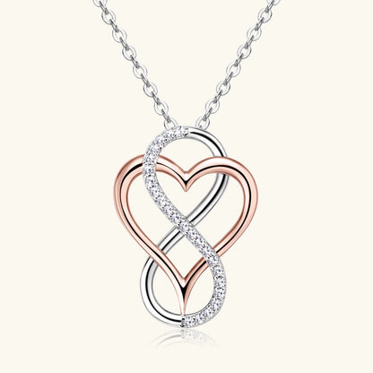 Jewelry necklace with a heart and infinity symbol pendant on a white background