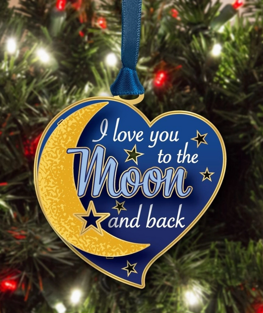 Heart-shaped ornament with 'I love you to the moon and back' text on a Christmas tree.