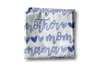 Waffle-textured towel with blue text and heart patterns on a white background