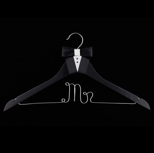 Black hanger with 'Mr' text and bow tie on a black background