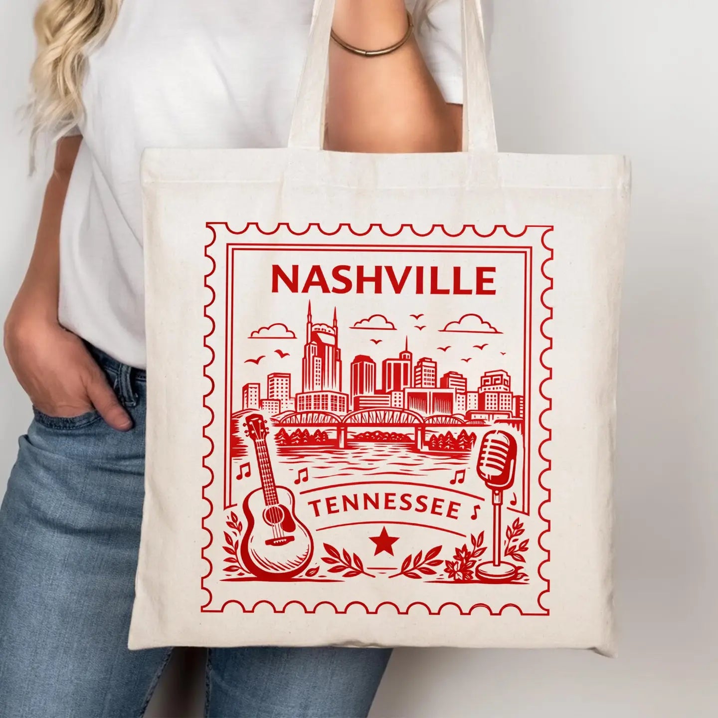 Tote bag with 'Nashville, Tennessee' design featuring a cityscape, guitar, and microphone.