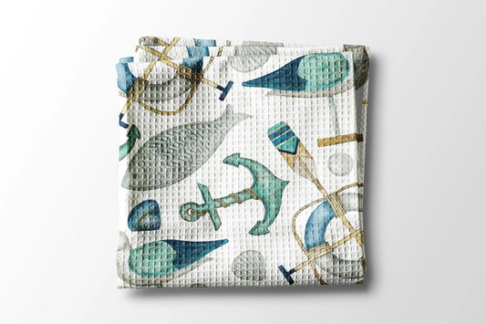 Woven blanket with nautical pattern on a white background