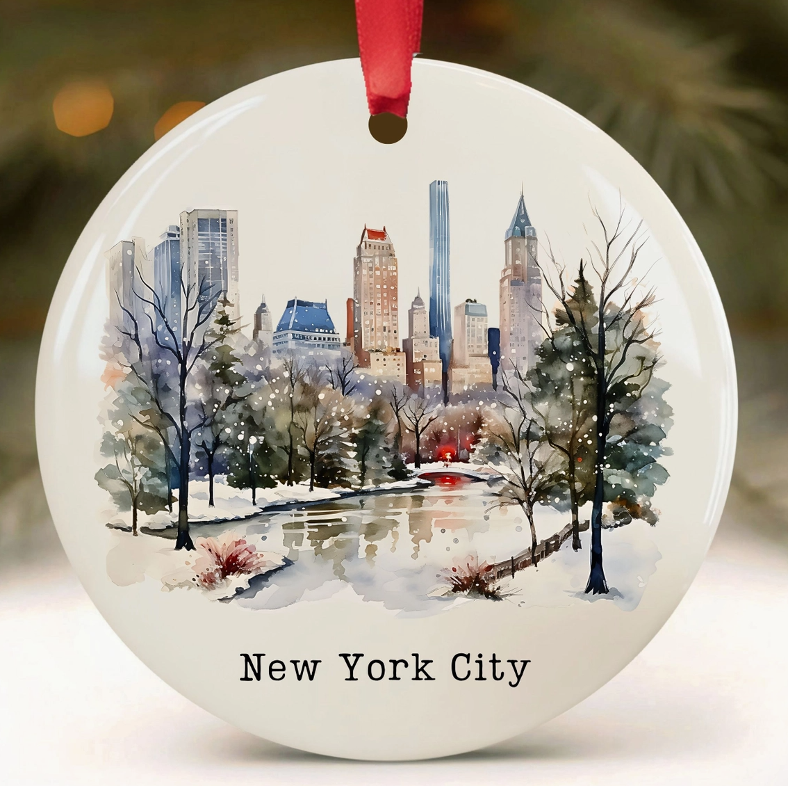 New York City Central Park ceramic Christmas ornament with watercolor-style snowy park scene and Manhattan skyline.