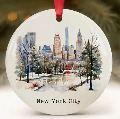 New York City Central Park ceramic Christmas ornament with watercolor-style snowy park scene and Manhattan skyline.