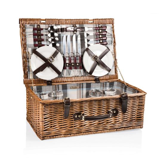Wicker picnic basket with cutlery and plates on a white background
