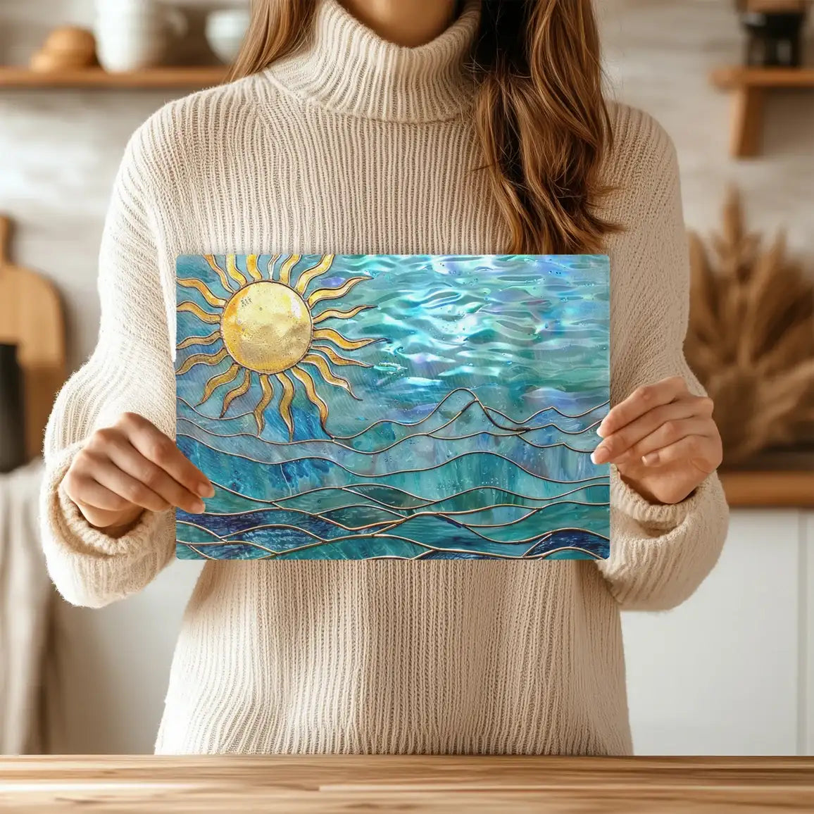 Person Holding up a glass cutting board with a design of ocean waves and an image of the sun in the left corner.