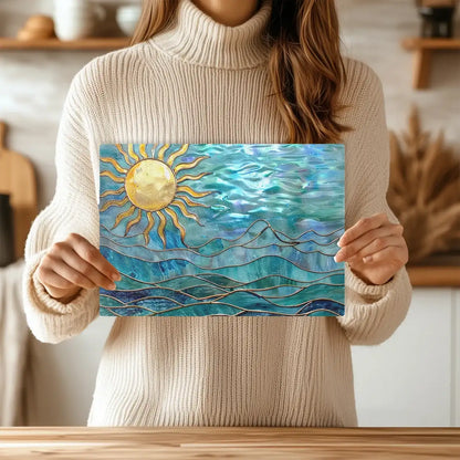 Person Holding up a glass cutting board with a design of ocean waves and an image of the sun in the left corner.