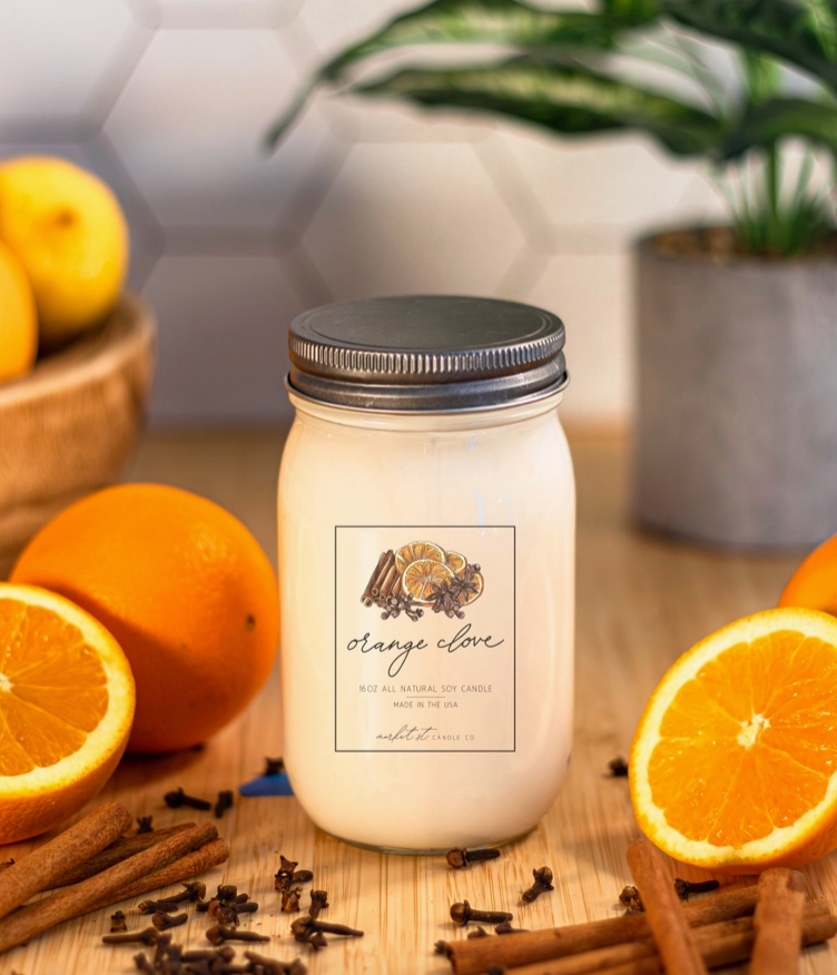 Close-up of Market Street Candle Co. Orange Clove candle label featuring illustrated orange slices and warming spices.
