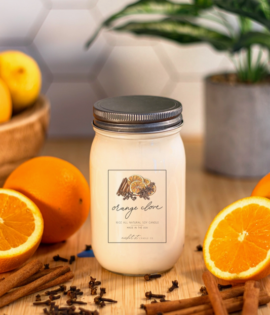 Close-up of Market Street Candle Co. Orange Clove candle label featuring illustrated orange slices and warming spices.