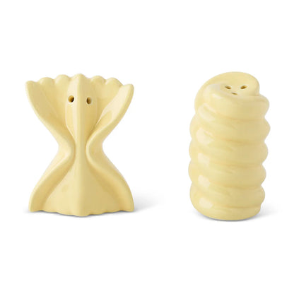 Two pale yellow ceramic salt and pepper shakers shaped like pasta, displayed side by side on a white background.