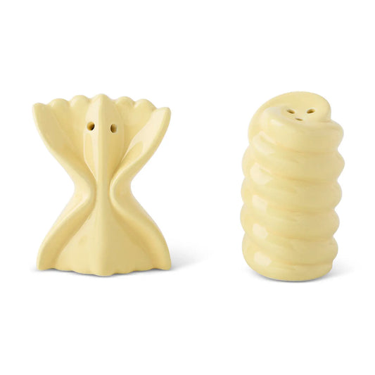 Two pale yellow ceramic salt and pepper shakers shaped like pasta, displayed side by side on a white background.