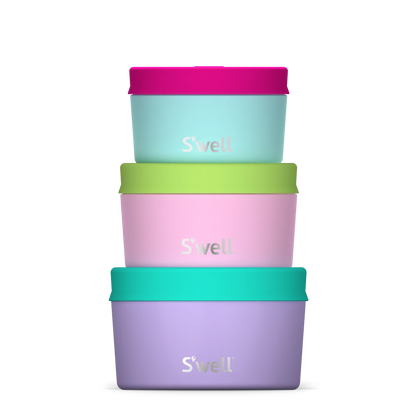 Set of three S'well water bottles in purple, pink, and green on a white background