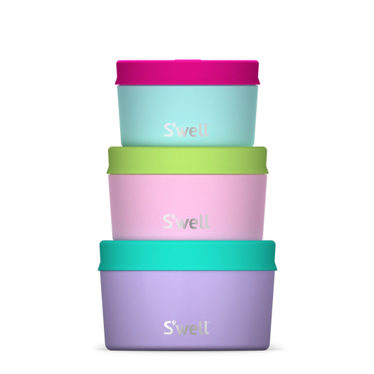 Set of three S'well water bottles in purple, pink, and green on a white background