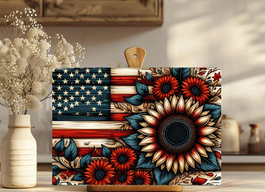 Decorative cutting board with floral and American flag design on a wooden surface.
